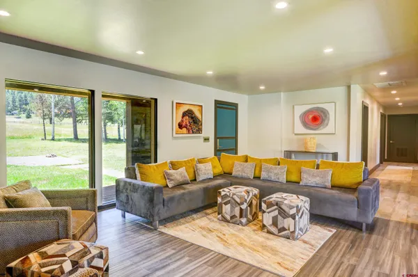 a living room with furniture and a floor to ceiling window