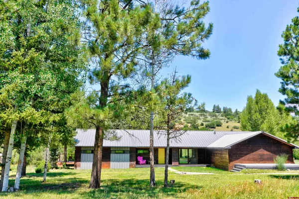 a view of an house with backyard space and garden