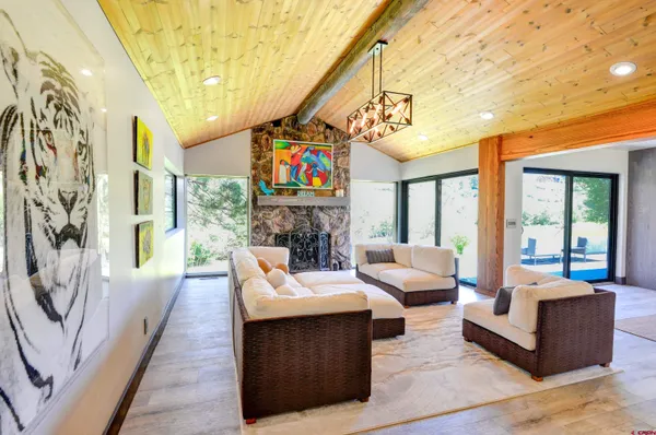 a living room with fireplace furniture and a chandelier