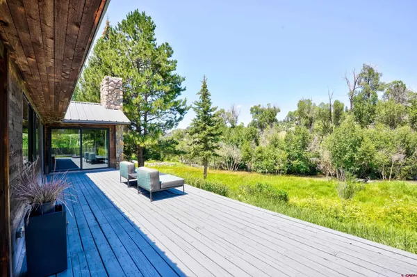a view of a house with backyard sitting area and garden