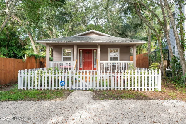 front view of a house with a porch and furniture