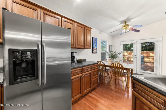 a backyard of a house with wooden floor a barbeque oven and outdoor seating