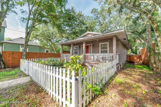 a view of a porch with a flower in a garden