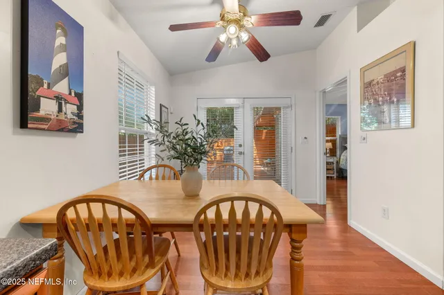 an aerial view of a house with a yard and a large tree