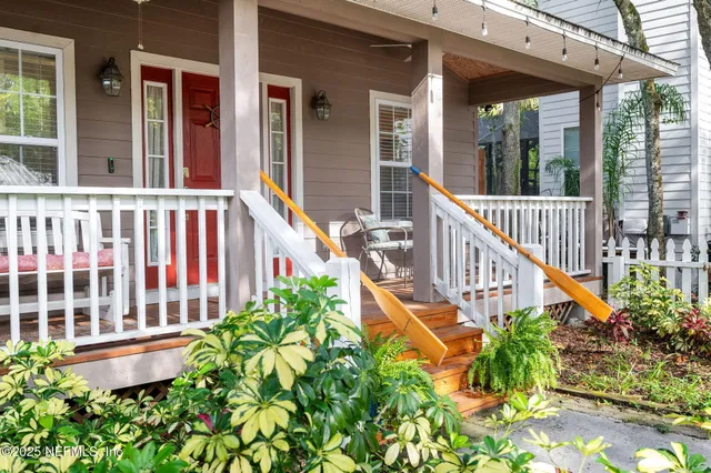 a hallway with white cabinets and wooden floor