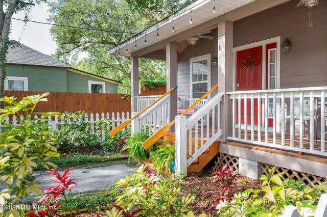 a living room with furniture kitchen view and a wooden floor
