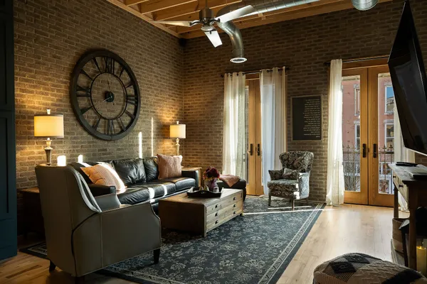 a living room with furniture a large window and a fireplace