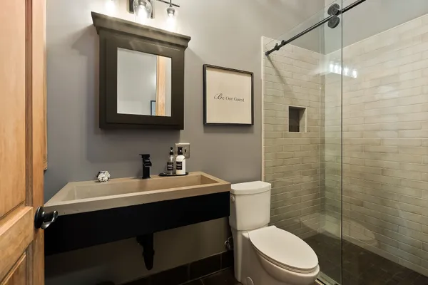 a bathroom with a tub sink and mirror