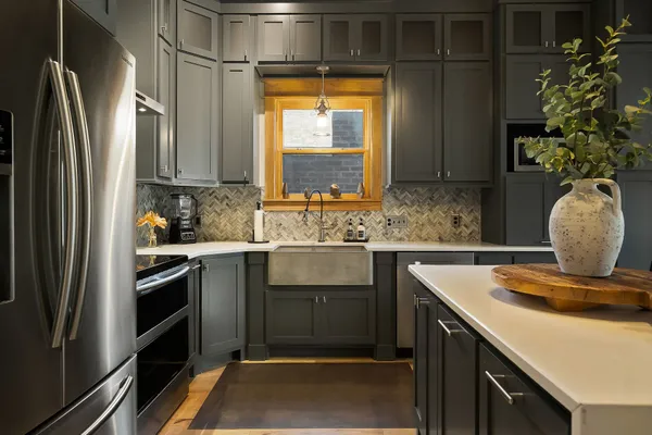 a kitchen with a refrigerator and a sink