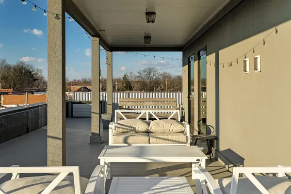 a view of a balcony with furniture