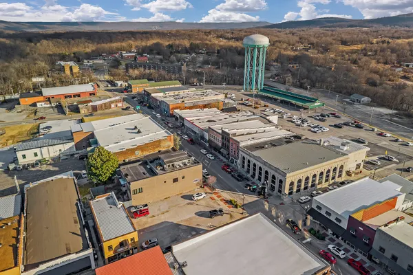 an aerial view of a building with parking
