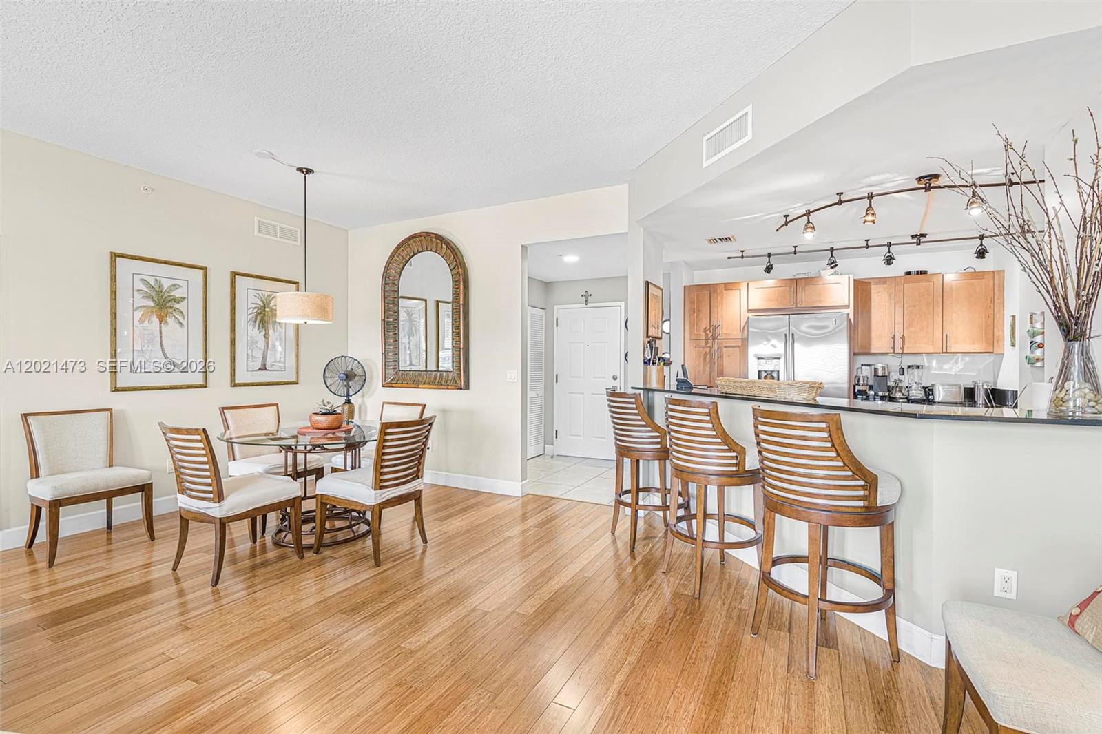 8395 Southwest 73rd Avenue, Unit 710 Miami, FL 33143 - Photo 11 of 32 a view of a dining room with furniture and wooden floor