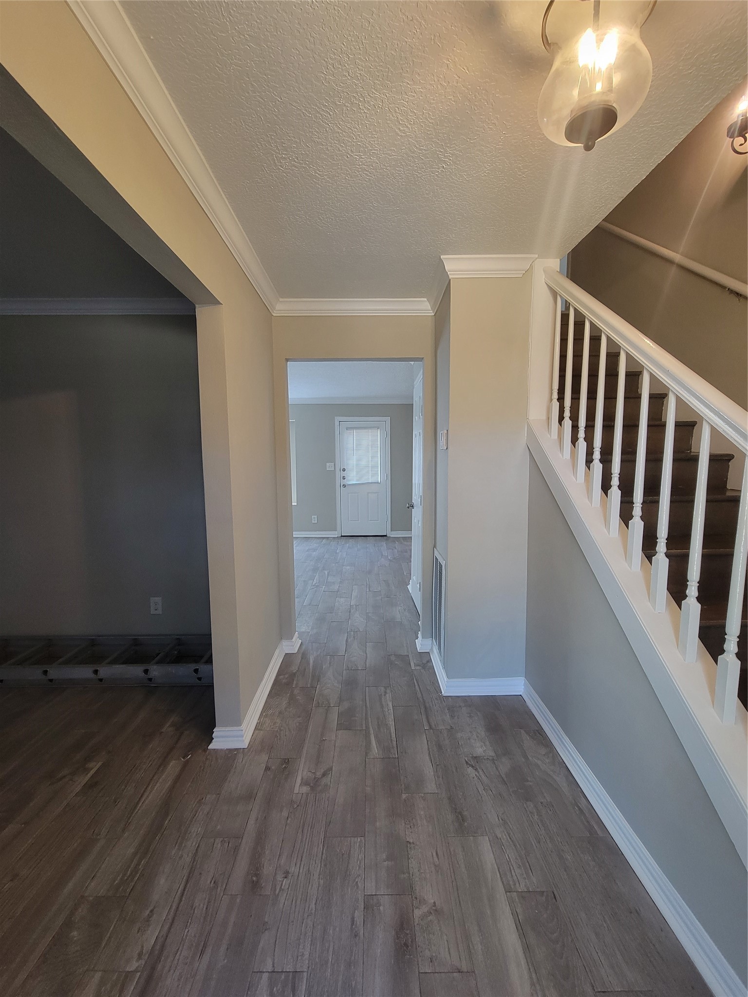 4015 Chapel Square Drive Spring, TX 77388 - Photo 4 of 27 Step into the inviting foyer, featuring a graceful staircase and a hallway leading to the spacious living area.