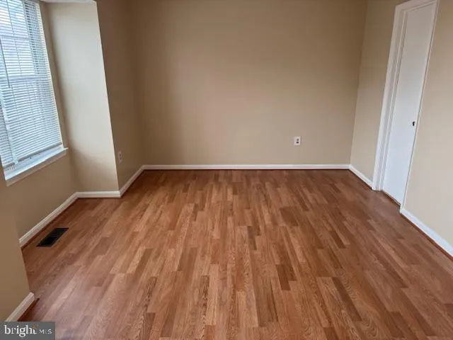 a view of an empty room and wooden floor