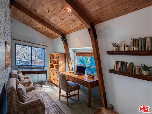 a work room with furniture and book shelf