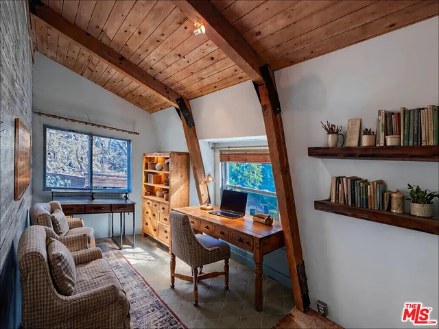 a work room with furniture and book shelf