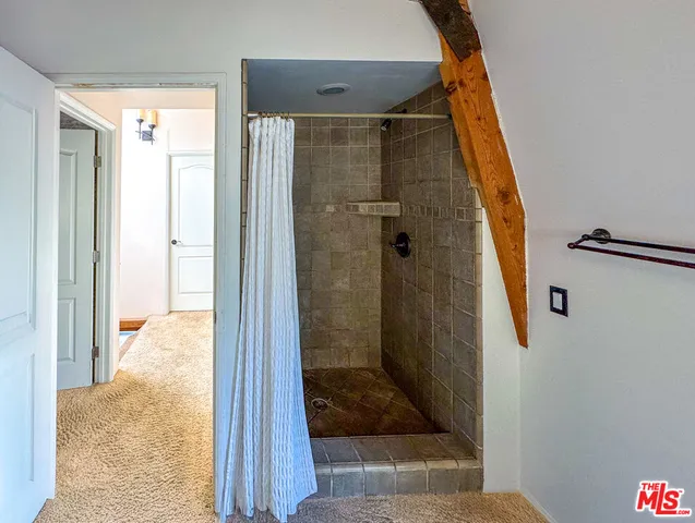 a bathroom with a glass shower door