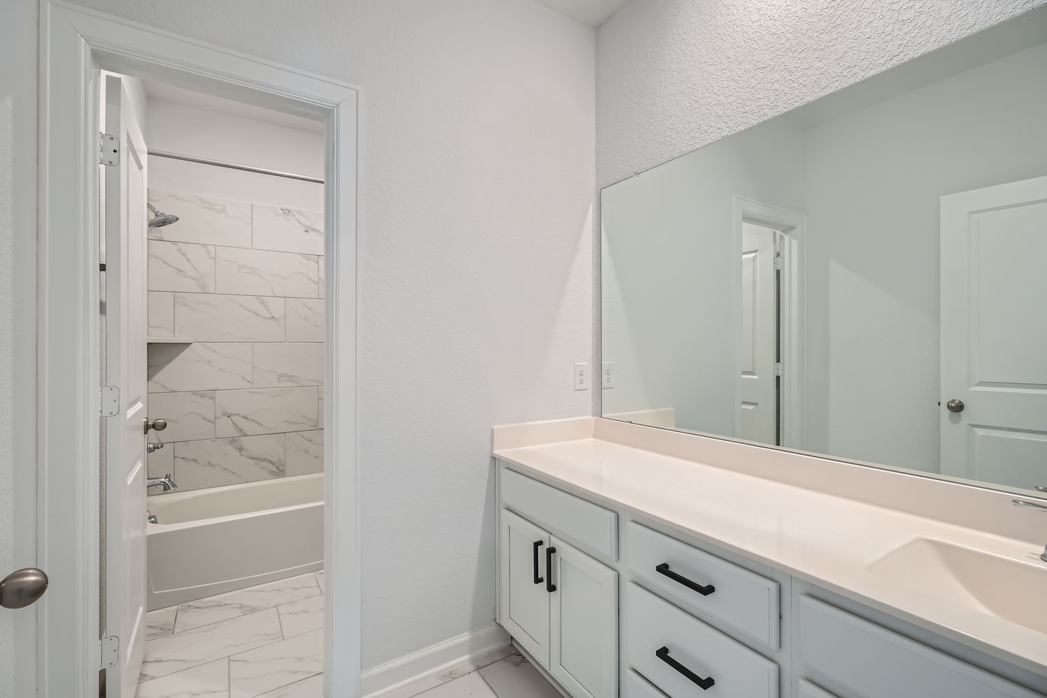 582 Wild Pecan Loop Buda, TX 78610 - Photo 22 of 28 Full bathroom featuring vanity, light marble finish floors, and tub / shower combination