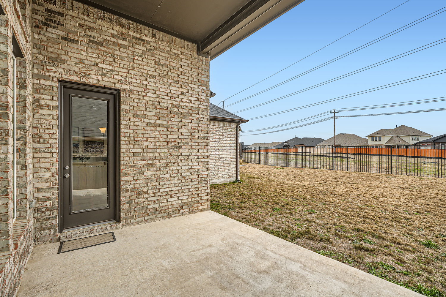 582 Wild Pecan Loop Buda, TX 78610 - Photo 25 of 28 Property entrance featuring a patio, brick siding, and a residential view