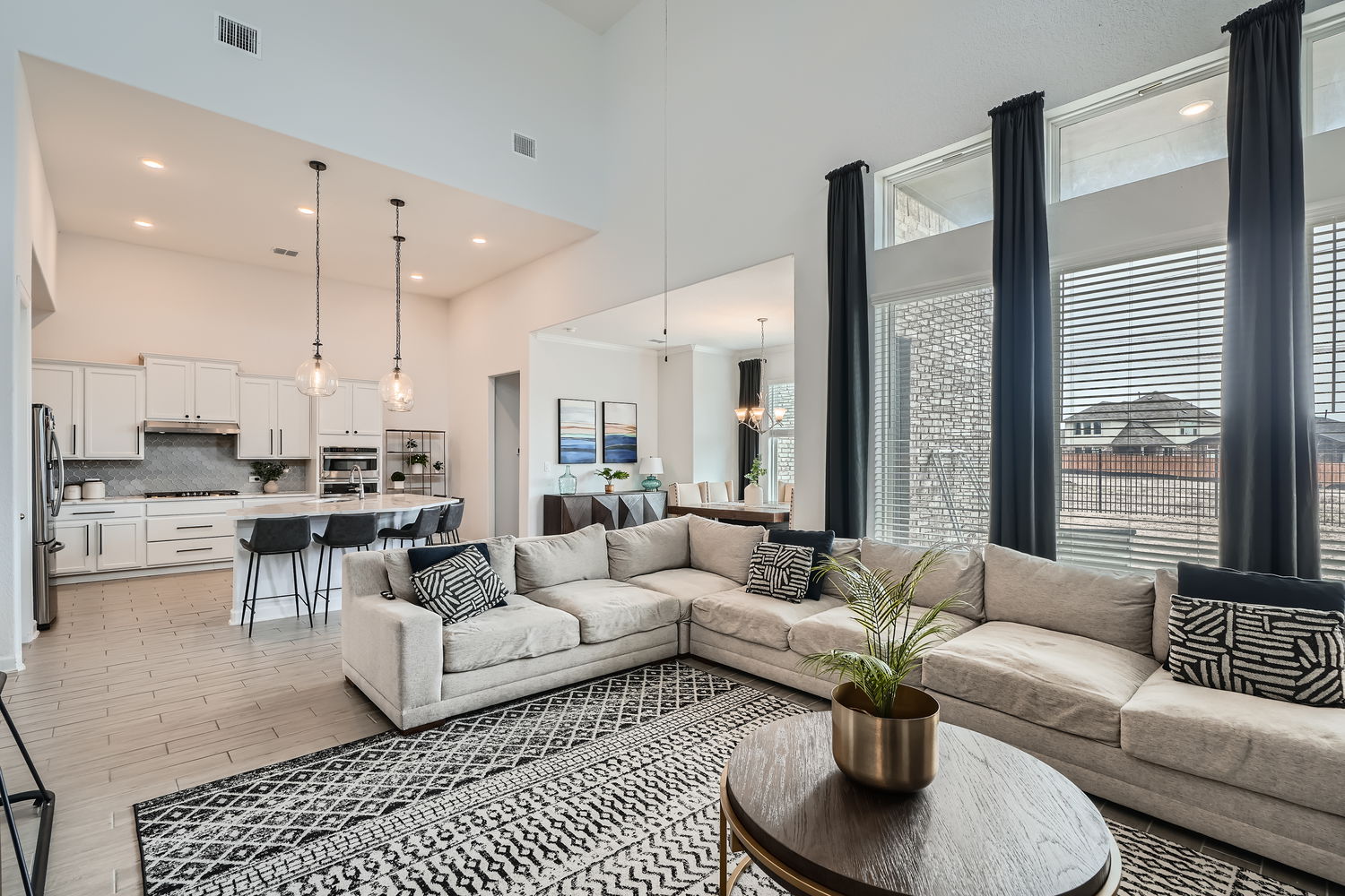 582 Wild Pecan Loop Buda, TX 78610 - Photo 7 of 28 Living area with wood finish floors, a high ceiling, and suspended lighting