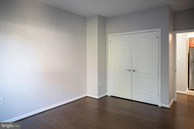 a view of an empty room and wooden floor