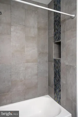 a bathroom with a shower and a sink