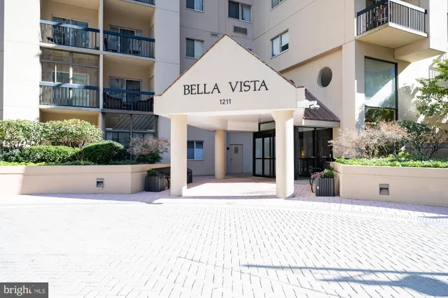 a view of a building with a lot of potted plants