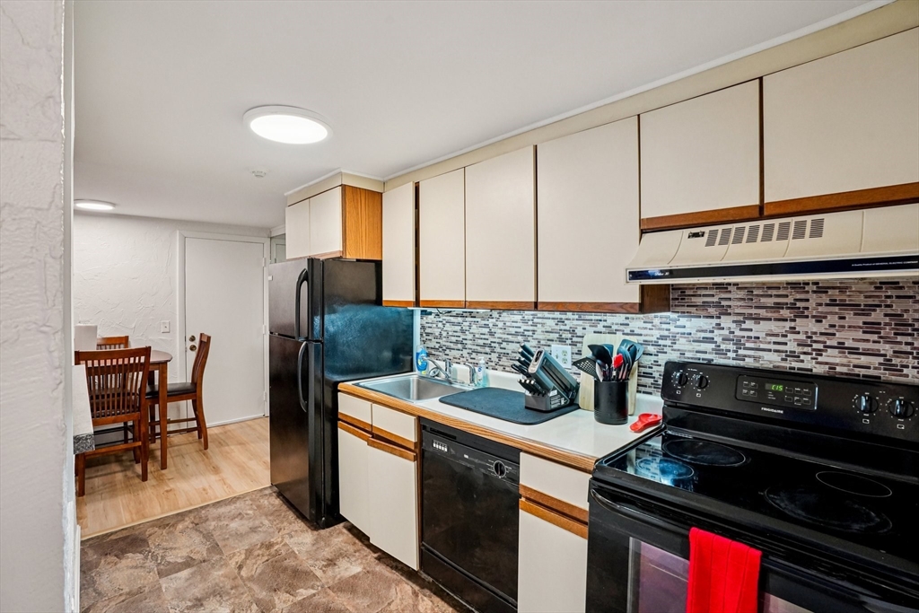 208 Swanson Road, Unit 526 Boxborough, MA 01719 - Photo 8 of 18 a kitchen with stainless steel appliances a stove a sink and cabinets