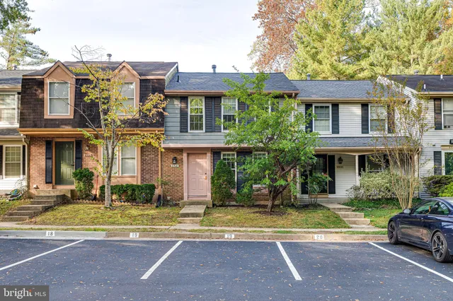 a front view of a residential apartment building with a yard