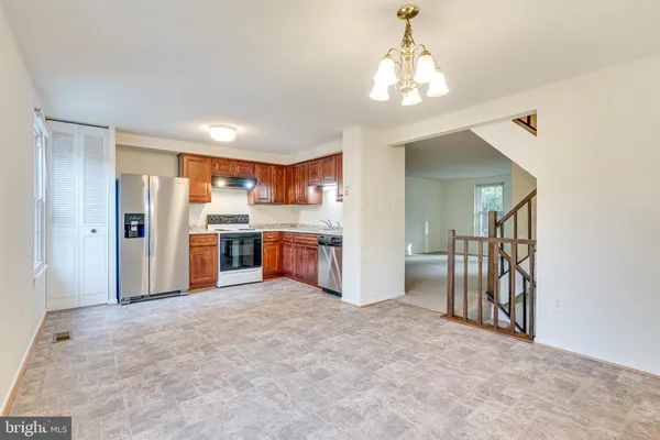 a view of a kitchen with a sink and a refrigerator