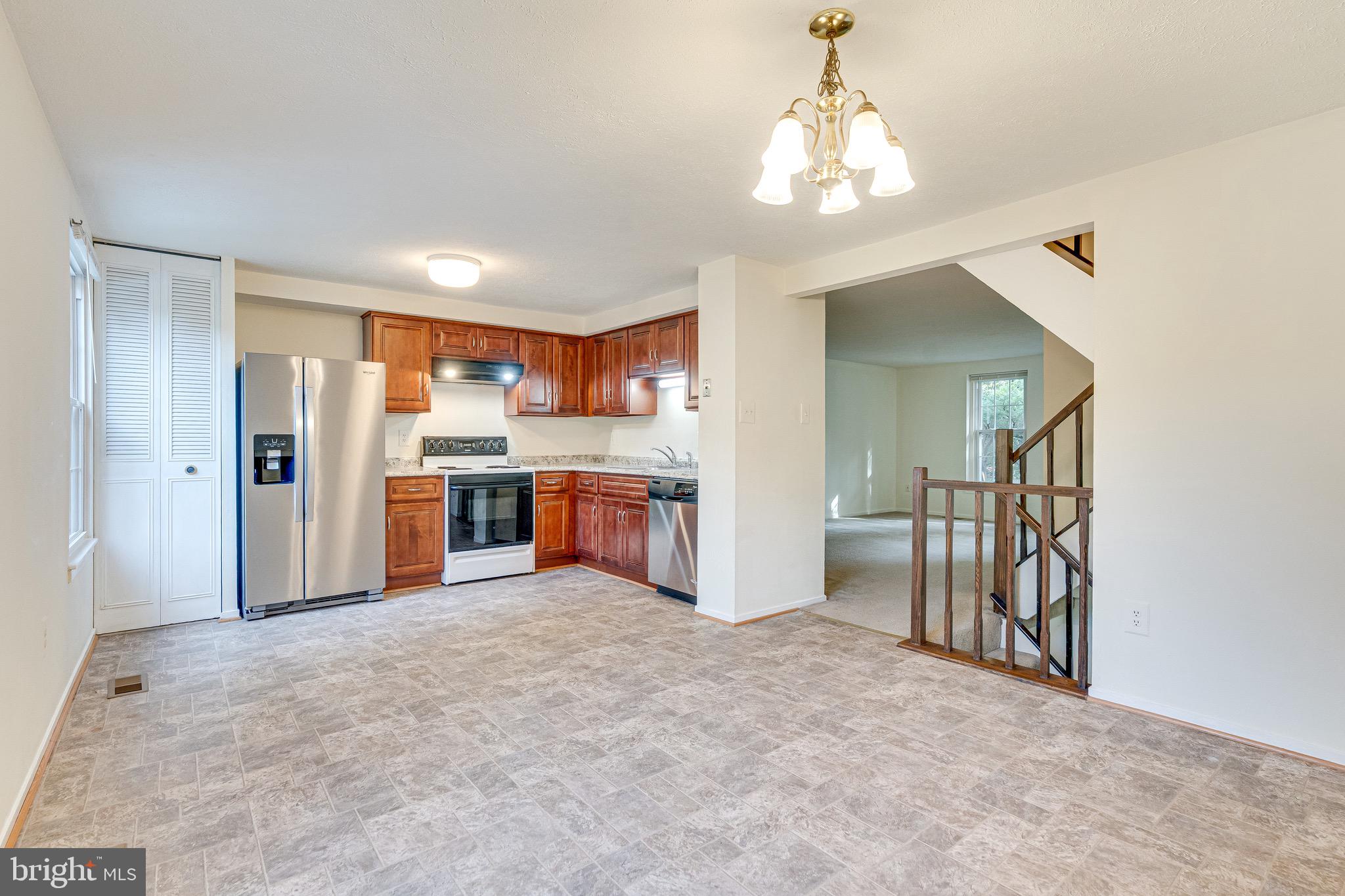 6518 Alexis Lane Springfield, VA 22152 - Photo 12 of 44 a view of a kitchen with a sink and a refrigerator