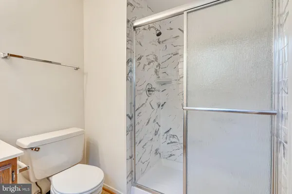 a white toilet sitting next to a shower curtain