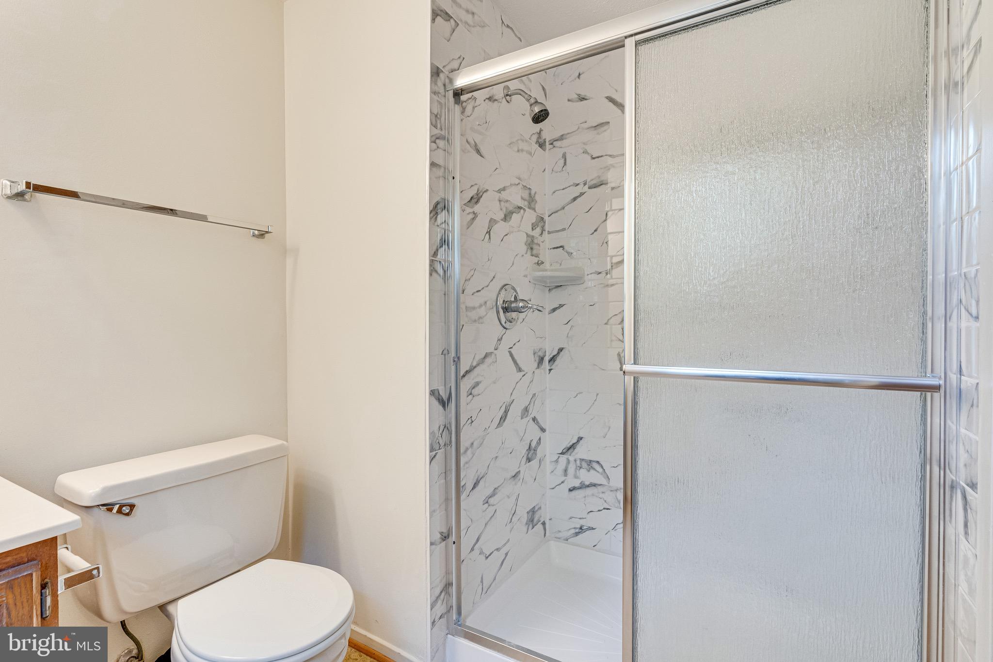 6518 Alexis Lane Springfield, VA 22152 - Photo 23 of 44 a white toilet sitting next to a shower curtain