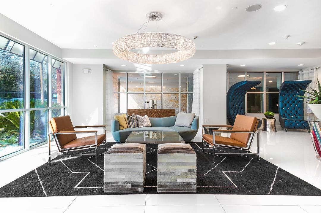 1900 Barton Springs Road, Unit 3040 Austin, TX 78704 - Photo 27 of 38 Bright interior space featuring a large statement chandelier and expansive window walls