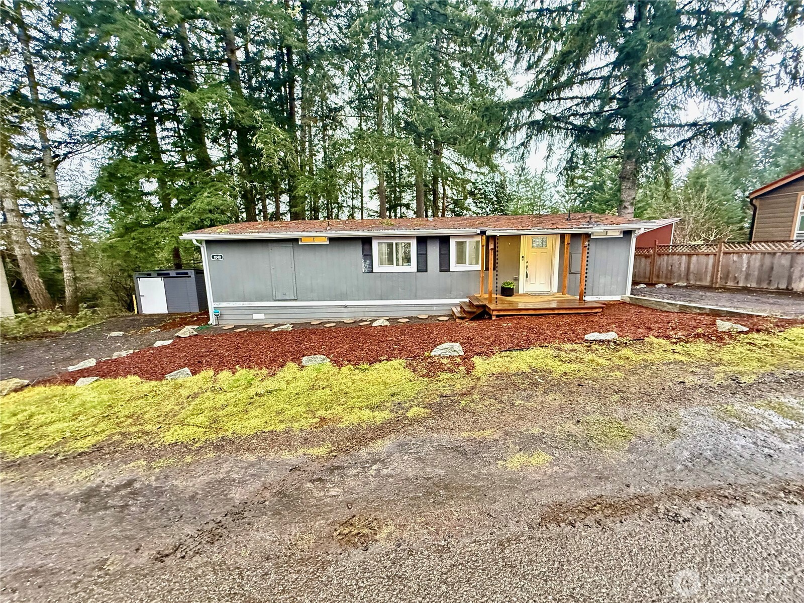 1040 Northeast Larson Boulevard Belfair, WA 98528 - Photo 1 of 18 a view of a house with backyard and trees