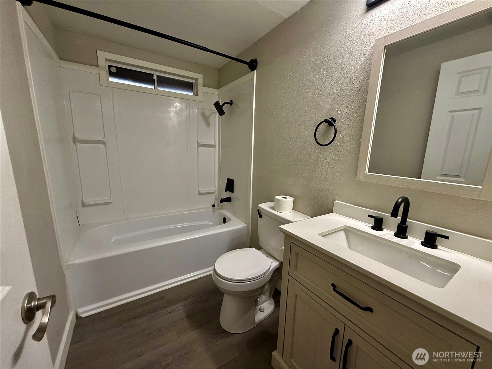 1040 Northeast Larson Boulevard Belfair, WA 98528 - Photo 11 of 18 a bathroom with a sink a toilet a mirror a vanity and shower