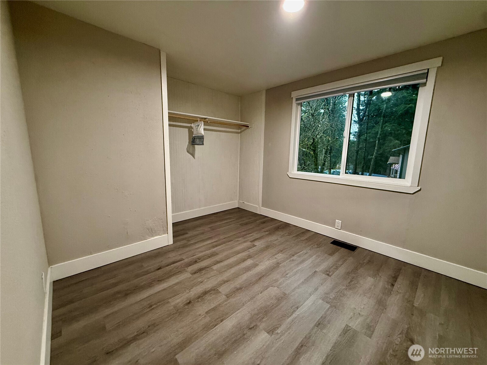 1040 Northeast Larson Boulevard Belfair, WA 98528 - Photo 17 of 18 an empty room with wooden floor and windows