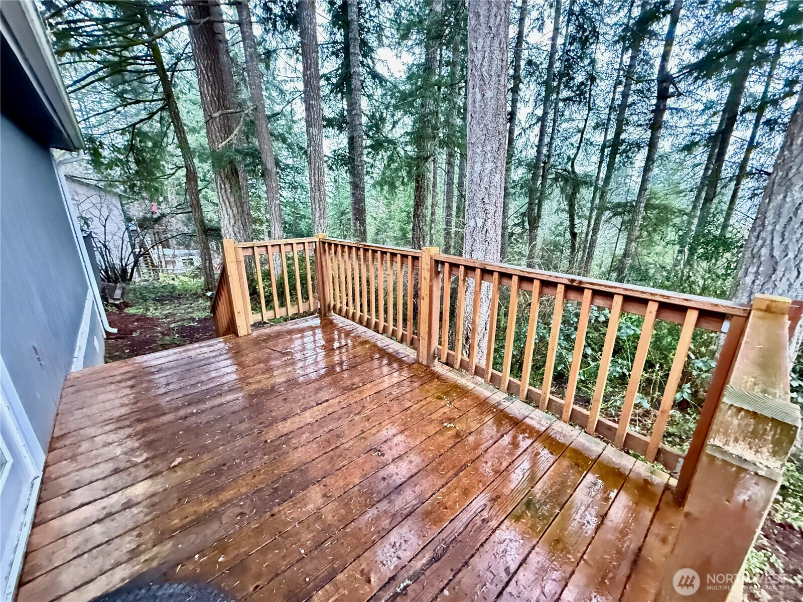 1040 Northeast Larson Boulevard Belfair, WA 98528 - Photo 5 of 18 a view of deck with a large window and wooden floor