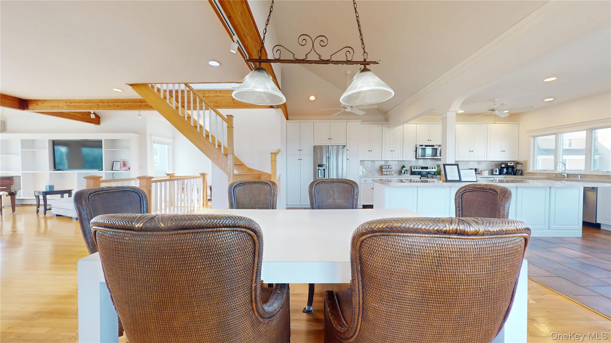 750 Dune Road West Hampton Dunes, NY 11978 - Photo 21 of 49 a living room with furniture kitchen view and a chandelier
