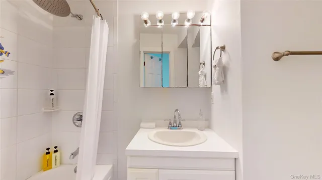 a large bed sitting in a room next to a cabinet