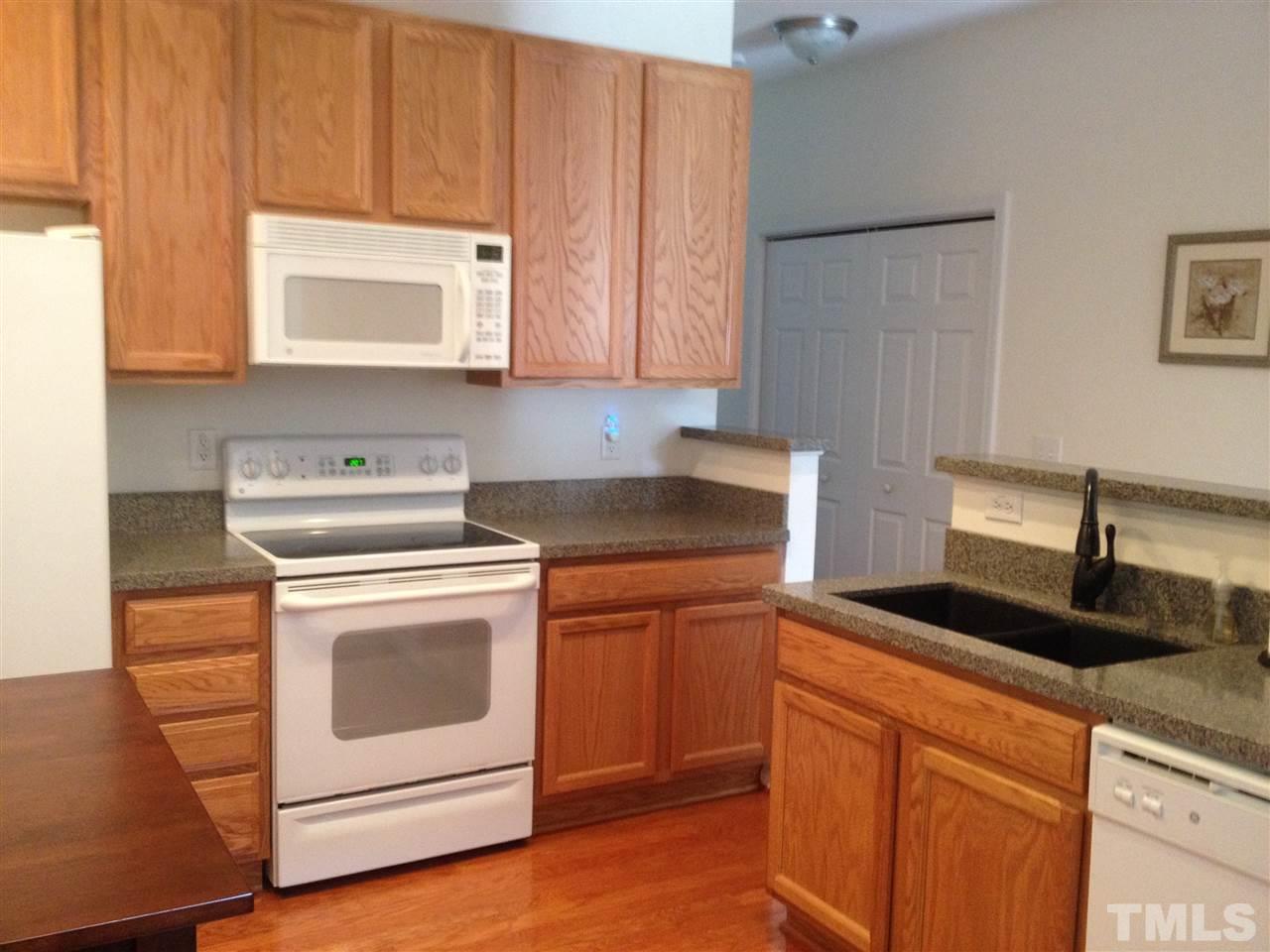 8514 Micollet Court Raleigh, NC 27613 - Photo 2 of 9 a kitchen with granite countertop cabinets stainless steel appliances and a sink