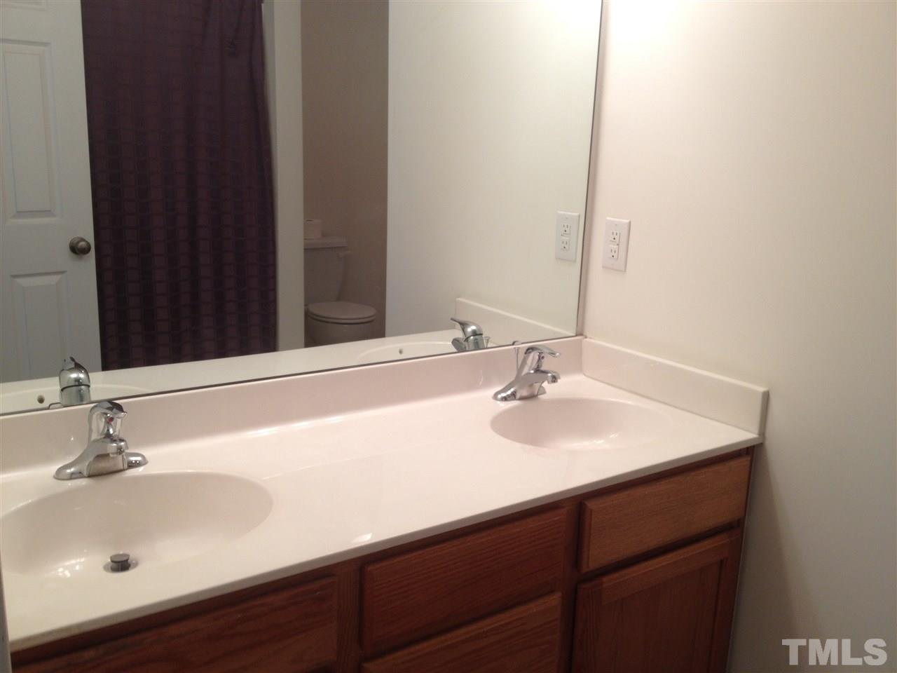 8514 Micollet Court Raleigh, NC 27613 - Photo 9 of 9 a bathroom with a sink and a mirror