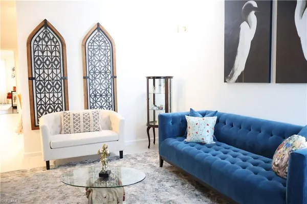 a living room with furniture and a mirror