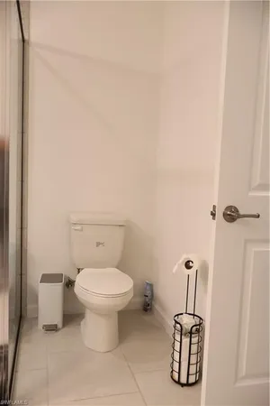 a white toilet sitting next to a bathroom