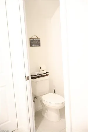 a white toilet sitting next to a shower curtain