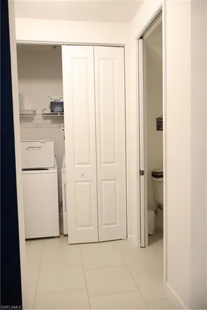 a view of a utility room with closet dryer and washer