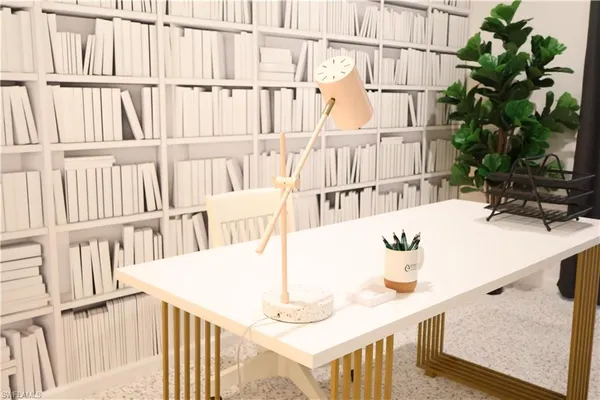 a view of furniture and a kitchen area with wooden floor
