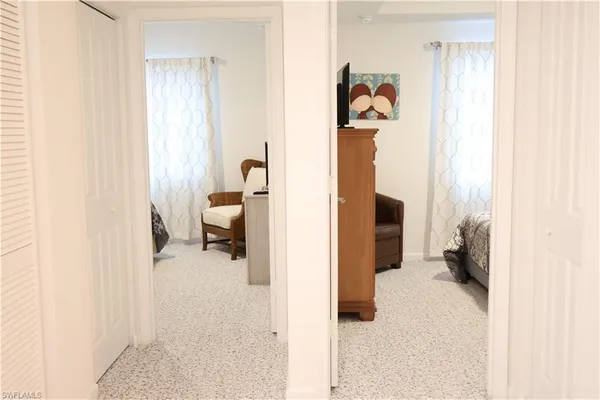 a hallway with kids room bathroom and a bathroom