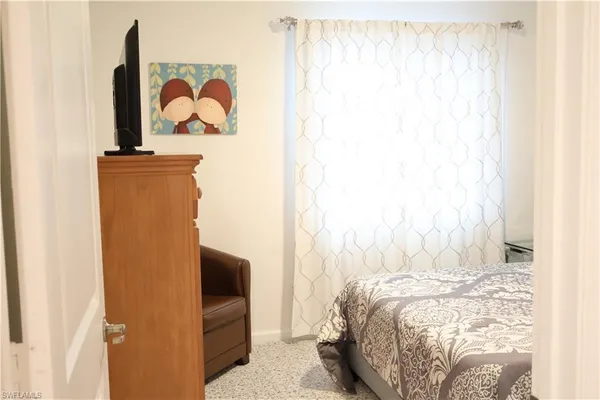 a bedroom with a bed and a wall painting