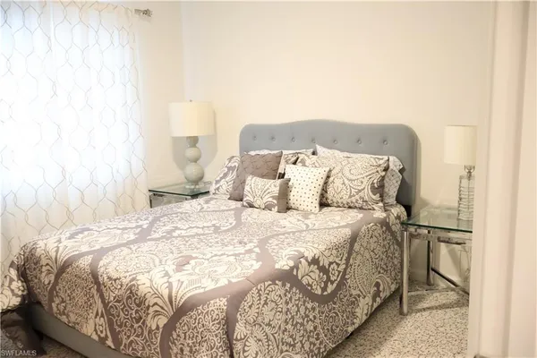 a bed sitting in a bedroom next to a window